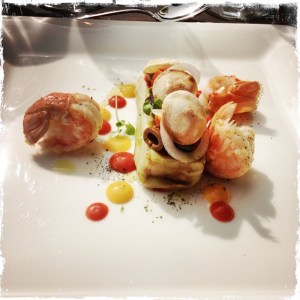 Pressed tomatoes from the garden with cottage cheese and basil, "Snacked" tails of Dublin Bay prawns from Britany, souffle bread and black olives.